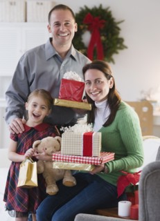 Family holding presents. Photographer: Jamie Grill