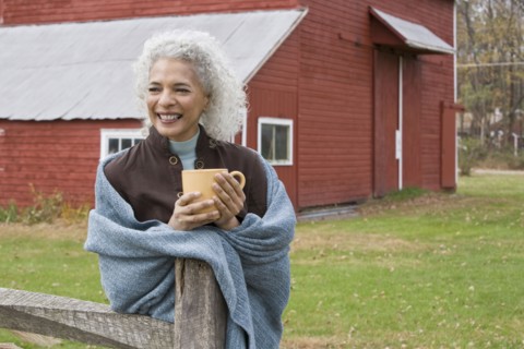 Woman holding mug outside. Photographer: Pauline St.Denis
