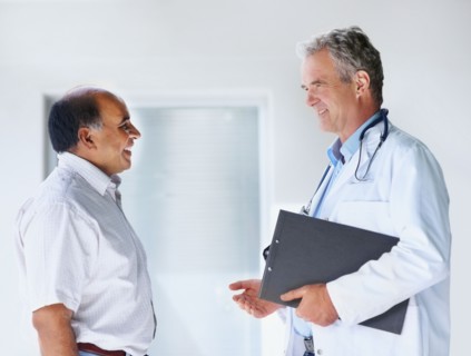 Doctor talking to patient. Photographer: momentimages