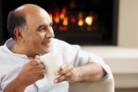 Man relaxing in living room. Photographer: momentimages
