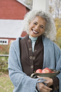 Woman holding bowl of apples. Photographer: Pauline St.Denis