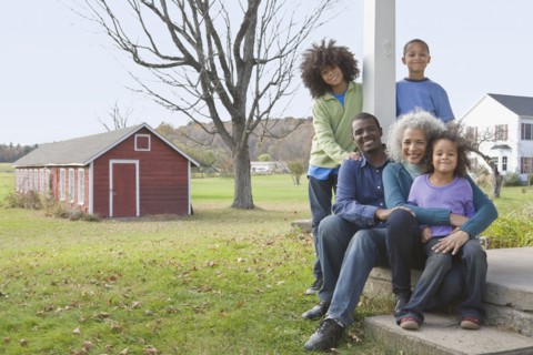 Family sitting on porch. Photographer: Pauline St.Denis