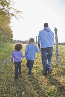 Father and children walking. Photographer: Pauline St.Denis