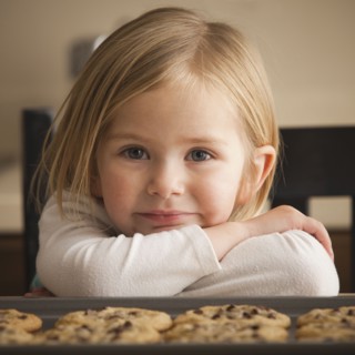 Girl waiting for cookies. Photographer: Mike Kemp