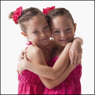 Twins embrace. Photographer: Mike Kemp