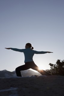 Woman doing yoga outdoors. Photographer: Dan Bannister