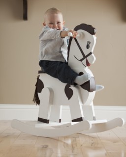 Baby on rocking horse. Photographer: Mike Kemp
