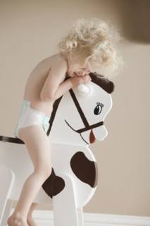 Toddler on rocking horse. Photographer: Mike Kemp
