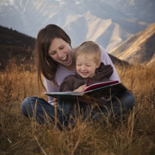 Mother and son reading outdoors. Photographer: Mike Kemp