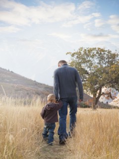Father and son walking outdoors. Photographer: Mike Kemp