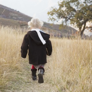 Girl walking in a meadow. Photographer: Mike Kemp