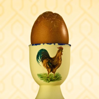 Cracked egg in cup. Photographer: Joe Clark