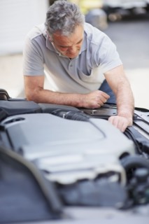 Man looking at car's engine. Photographer: momentimages
