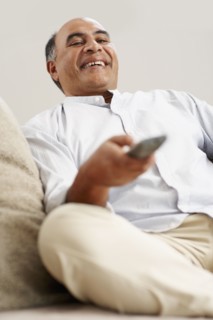 Man watching television. Photographer: momentimages
