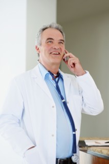 Doctor talking on phone. Photographer: momentimages