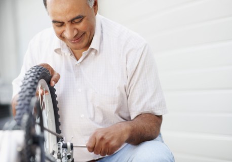 Man repairing bicycle. Photographer: momentimages