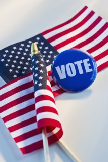 Election pin and American flags.