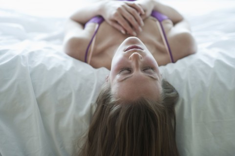 Woman lying on bed.