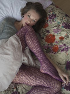 Woman lying down on bed.