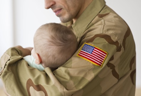 Soldier holding baby.