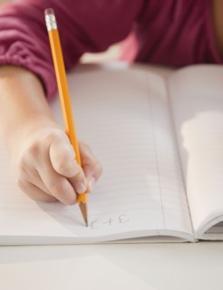 Young girl doing math homework. Photographer: Jamie Grill