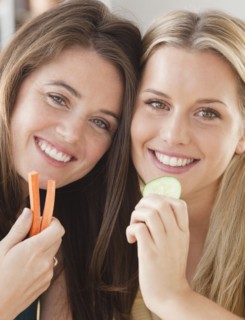 Friends eating vegetables. Photographer: Jamie Grill