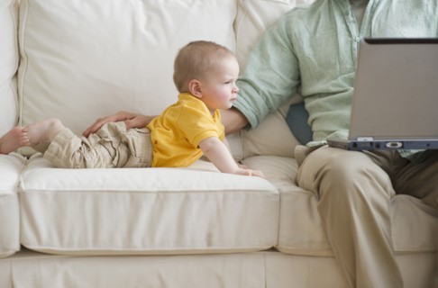 Father and son on couch.