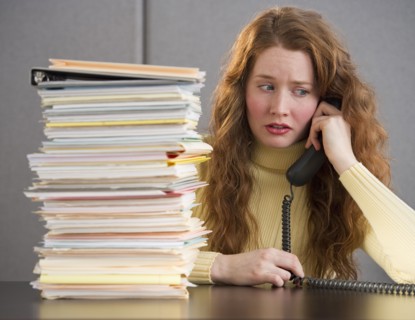 Overworked woman in cubicle.