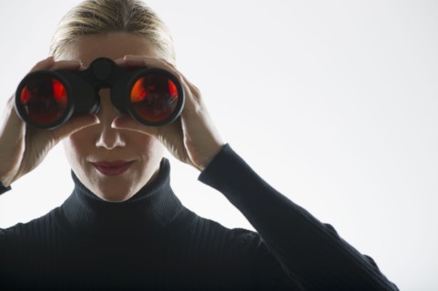 Woman looking through binoculars.