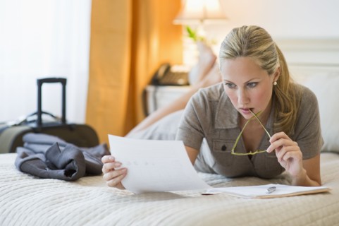 Woman working in hotel room.