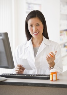 Pharmacist holding prescription medication.