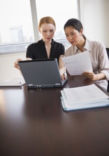 Businesswomen working in conference room.