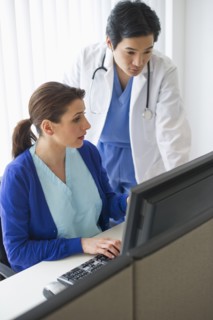 Doctor and nurse looking at computer.