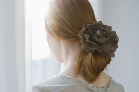 Woman's hair tied with a flower.