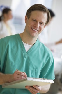 Doctor writing on chart.