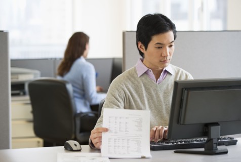 Man working in cubicle.