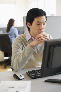 Man working in cubicle.