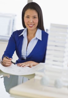 Female architect looking at blueprints.
