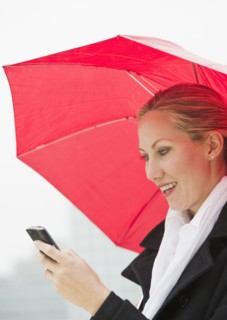 Woman texting on a rainy day.