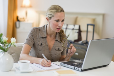 Woman working in hotel room.