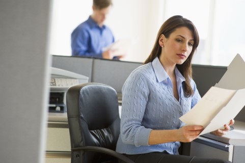 Woman working in cubicle.