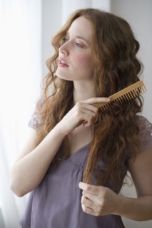 Woman combing her hair.