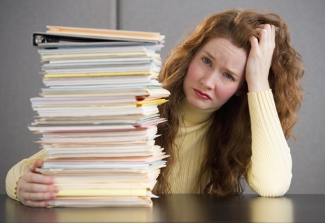 Overworked woman in cubicle.