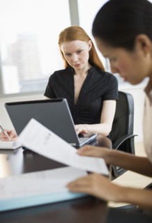 Businesswomen working in conference room.