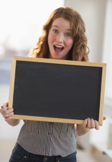 Woman holding a blank chalkboard.