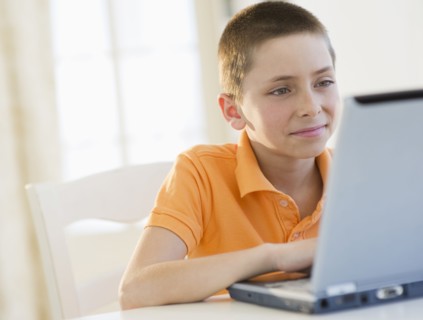 Young boy working on laptop.