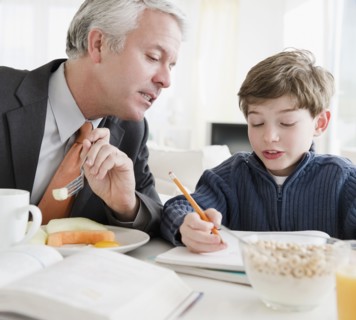 Father helping son with homework. Photographe : Jamie Grill