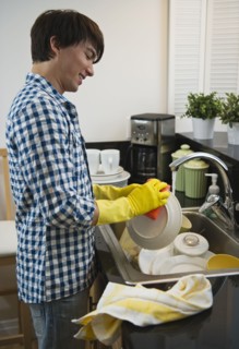 Man washing dishes. Photographe : Daniel Grill