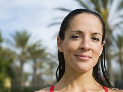 Woman standing in front of palm trees.