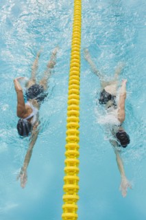 Women swimming laps in pool.